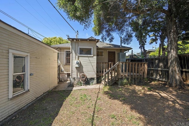 back of house featuring fence