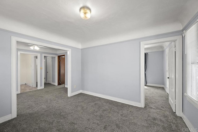 carpeted spare room with baseboards