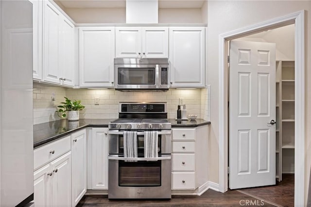 8029 Spencer St, Chino, CA 91708 - kitchen with stainless steel appliances, dark countertops, white cabinets, and decorative backsplash