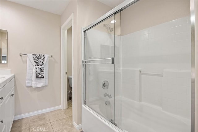 8029 Spencer St, Chino, CA 91708 - full bath featuring vanity, shower / bath combination with glass door, baseboards, toilet, and tile patterned flooring