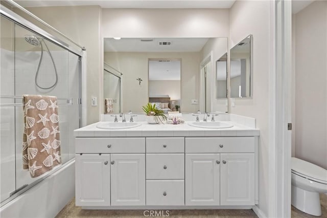8029 Spencer St, Chino, CA 91708 - bathroom featuring toilet, double vanity, and shower / bath combination with glass door
