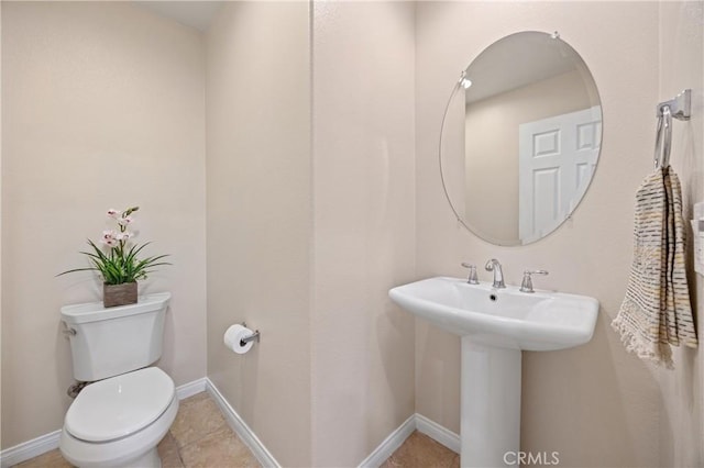 8029 Spencer St, Chino, CA 91708 - bathroom with toilet, a sink, and baseboards