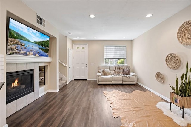 8029 Spencer St, Chino, CA 91708 - living area with stairway, wood finished floors, a fireplace, recessed lighting, and baseboards