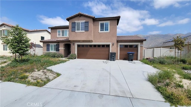 635 Moondance Ln, San Jacinto, CA 92583 - view of front facade featuring stucco siding, a tiled roof, concrete driveway, and fence