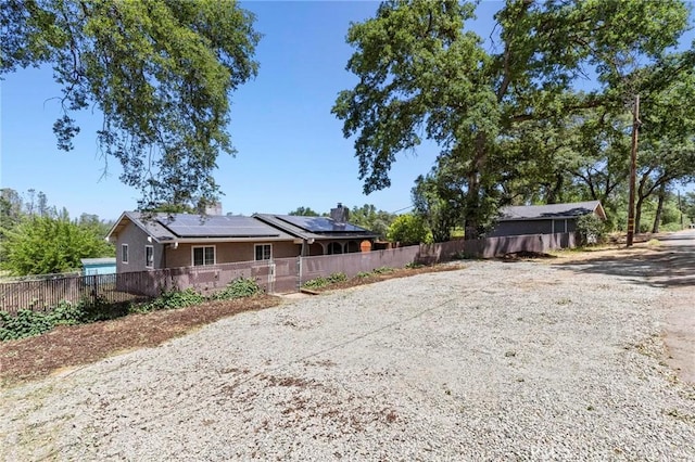 2681 Pinecrest Rd, Oroville, CA 95966 - back of property with solar panels, fence, and stucco siding