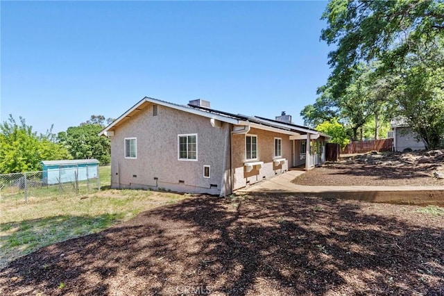 2681 Pinecrest Rd, Oroville, CA 95966 - back of house with a fenced backyard, stucco siding, crawl space, and a chimney