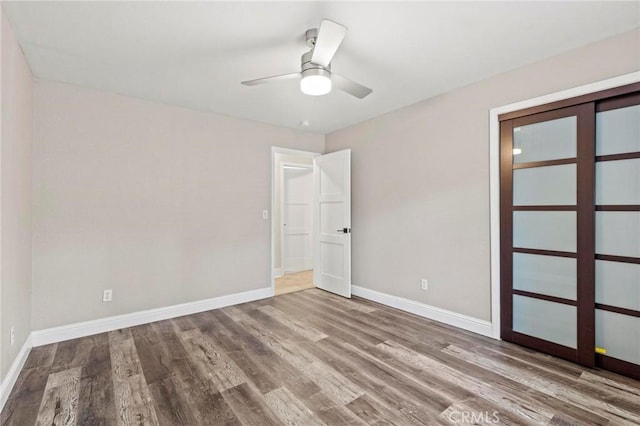 2681 Pinecrest Rd, Oroville, CA 95966 - unfurnished bedroom featuring wood finished floors, baseboards, and ceiling fan