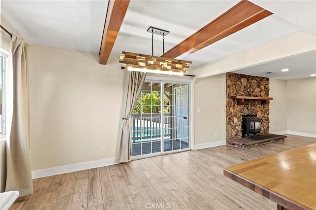 2681 Pinecrest Rd, Oroville, CA 95966 - unfurnished living room with wood finished floors, beamed ceiling, baseboards, and a wood stove