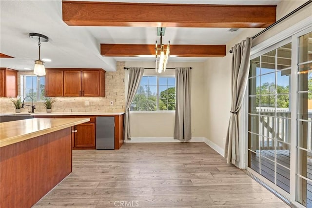 2681 Pinecrest Rd, Oroville, CA 95966 - kitchen with baseboards, light wood-type flooring, wood counters, a sink, and tasteful backsplash