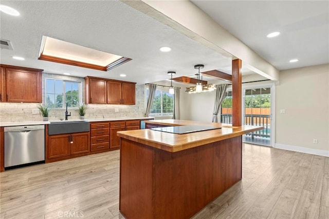 2681 Pinecrest Rd, Oroville, CA 95966 - kitchen with dishwasher, a sink, light wood finished floors, backsplash, and a center island