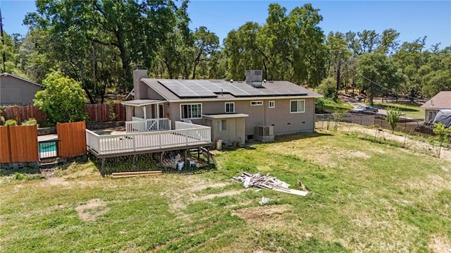 2681 Pinecrest Rd, Oroville, CA 95966 - back of house with a wooden deck, cooling unit, solar panels, and a chimney