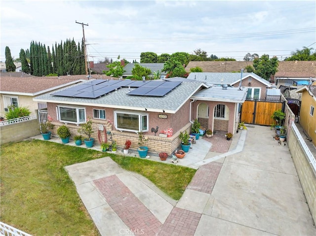 15726 Cameo Ave, Norwalk, CA 90650 - bungalow-style home featuring roof with shingles, solar panels, brick siding, and stucco siding