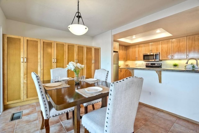 13063 Caminito Del Rocio, Del Mar, CA 92014 - dining space featuring light tile patterned floors and a tray ceiling