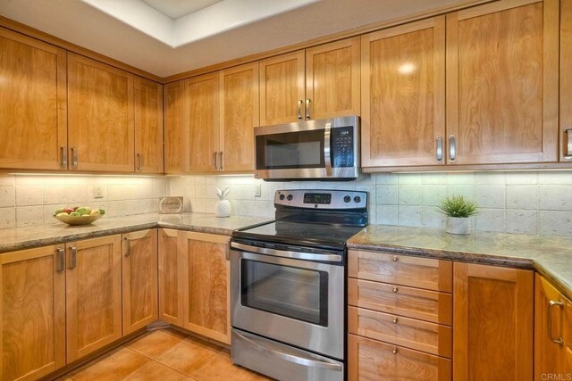13063 Caminito Del Rocio, Del Mar, CA 92014 - kitchen with stainless steel appliances, tasteful backsplash, and light stone counters
