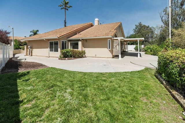 30602 Colina Verde St, Temecula, CA 92592 - back of house with a patio area, a tile roof, stucco siding, a chimney, and a carport