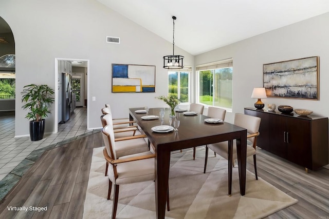 30602 Colina Verde St, Temecula, CA 92592 - dining space with wood finished floors, arched walkways, high vaulted ceiling, and baseboards