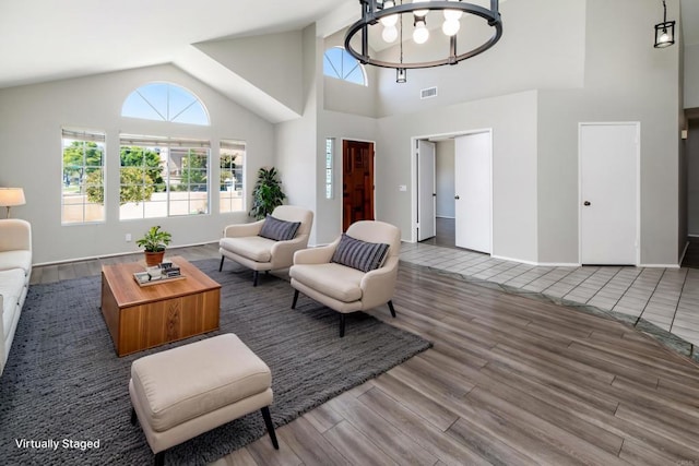 30602 Colina Verde St, Temecula, CA 92592 - living area featuring wood finished floors, a chandelier, high vaulted ceiling, and baseboards