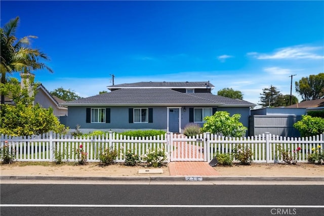 228 Del Mar Ave, Costa Mesa, CA 92627 - view of front of property with stucco siding, a fenced front yard, and a shingled roof