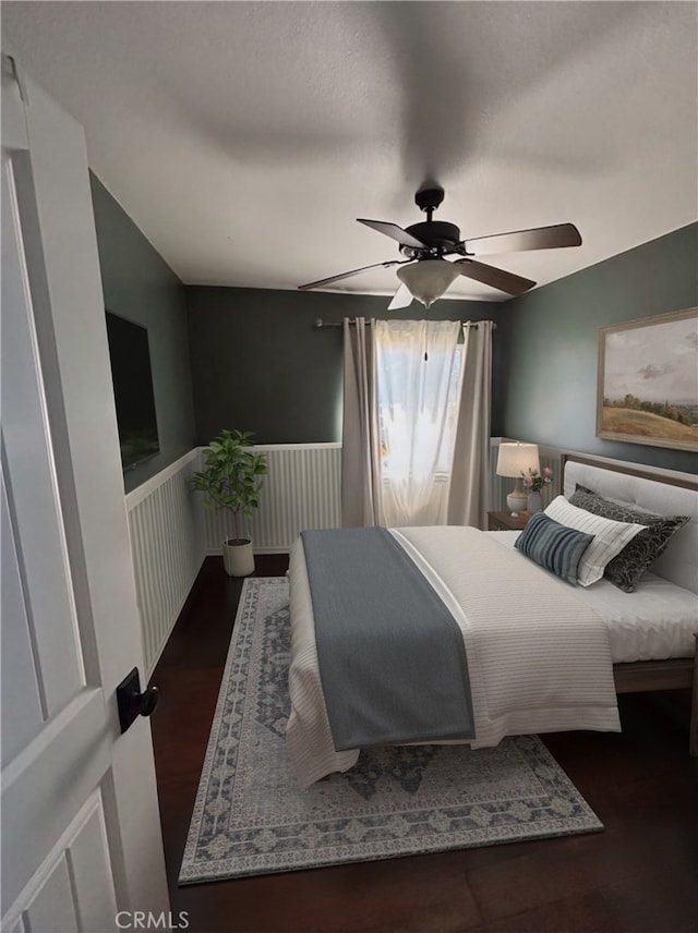 228 Del Mar Ave, Costa Mesa, CA 92627 - bedroom with a ceiling fan, wainscoting, and wood finished floors