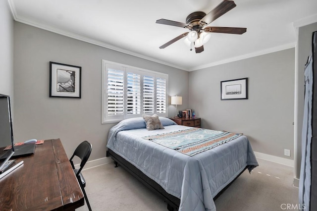 carpeted bedroom with baseboards, crown molding, a desk, and a ceiling fan