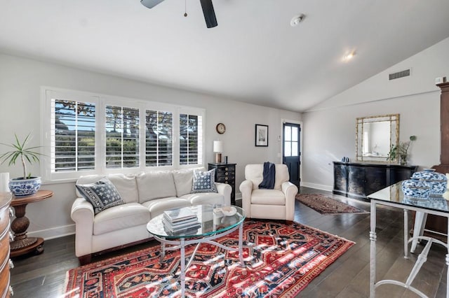living room featuring baseboards, ceiling fan, vaulted ceiling, and wood-type flooring