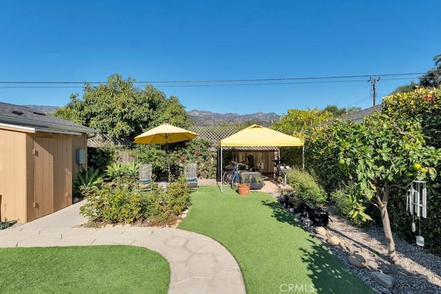 view of grassy yard with a gazebo and a mountain view