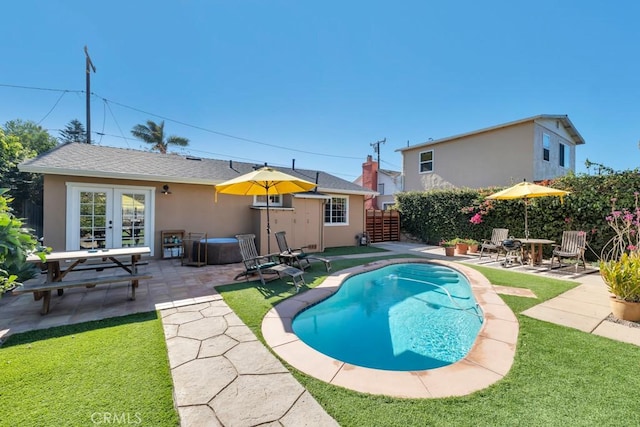view of pool with french doors and a patio