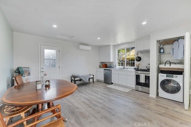 dining room with washer / clothes dryer, a wall unit AC, light wood-style flooring, and recessed lighting