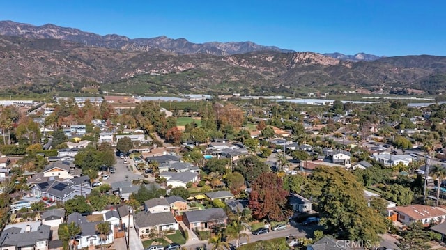 aerial overview of property's location with a mountain backdrop and nearby suburban area