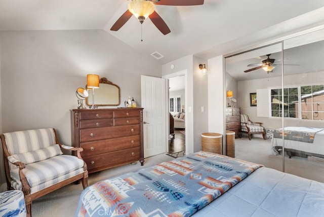 bedroom featuring lofted ceiling, carpet, ceiling fan, and a closet