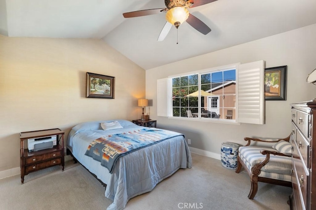carpeted bedroom with lofted ceiling, a ceiling fan, and baseboards
