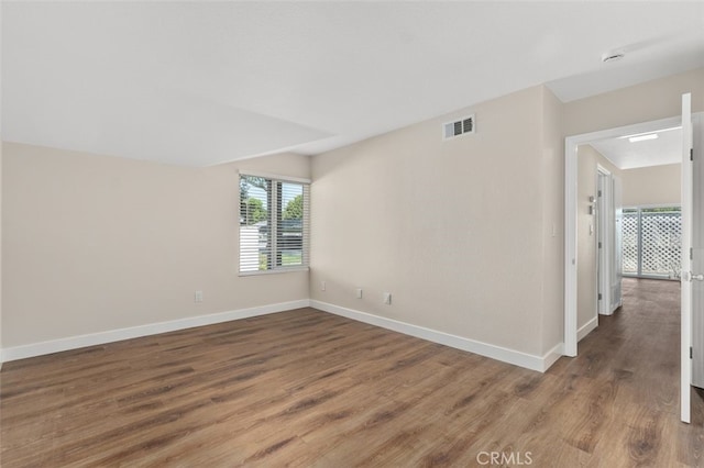 empty room with wood finished floors and baseboards