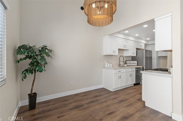 kitchen with a sink, stainless steel appliances, light countertops, recessed lighting, and dark wood-style floors