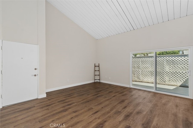 spare room with wood finished floors, baseboards, and high vaulted ceiling