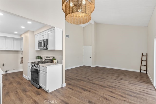 kitchen with stainless steel appliances, recessed lighting, dark wood-type flooring, light countertops, and white cabinets