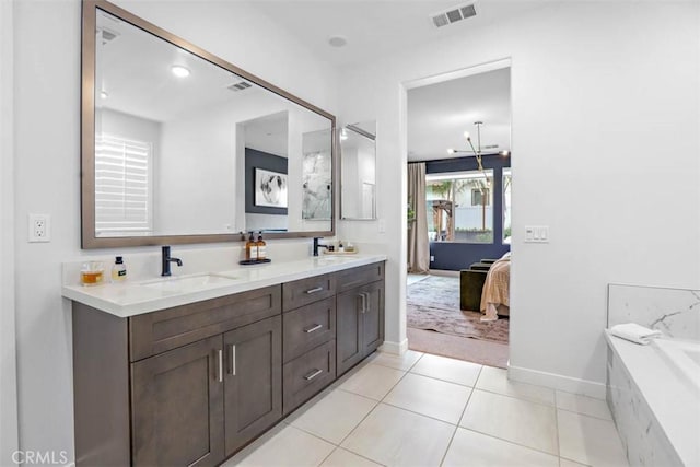 1772 Lundy Ln, Beaumont, CA 92223 - ensuite bathroom with baseboards, double vanity, tile patterned flooring, and a bath