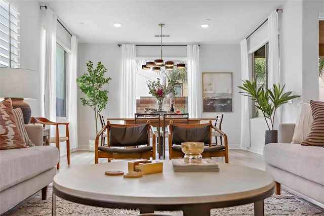 1772 Lundy Ln, Beaumont, CA 92223 - dining room featuring light wood-type flooring, a chandelier, recessed lighting, and baseboards