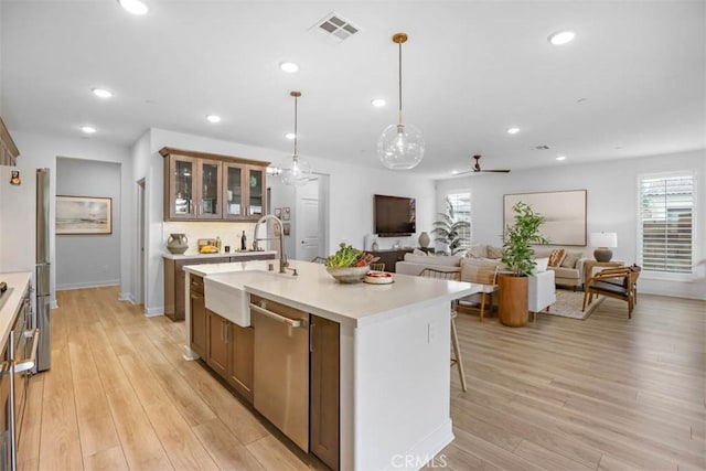 1772 Lundy Ln, Beaumont, CA 92223 - kitchen with a sink, dishwasher, light countertops, recessed lighting, and light wood finished floors