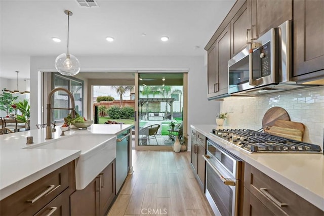 1772 Lundy Ln, Beaumont, CA 92223 - kitchen featuring stainless steel appliances, a sink, recessed lighting, light countertops, and backsplash