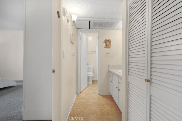 full bath featuring toilet, a closet, tile patterned floors, vanity, and connected bathroom