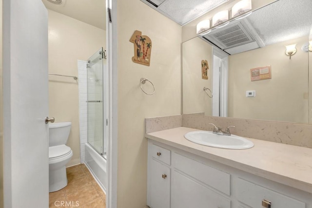 bathroom with toilet, tile patterned flooring, vanity, and shower / tub combination