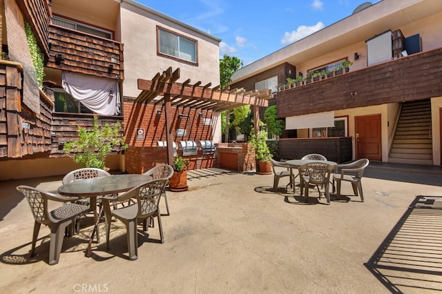 view of patio featuring outdoor dining space and a pergola