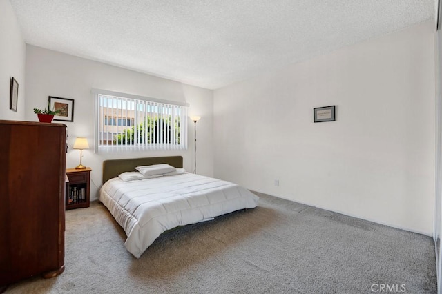 carpeted bedroom featuring a textured ceiling