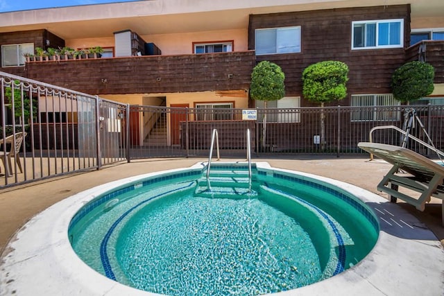 view of swimming pool with fence and a patio