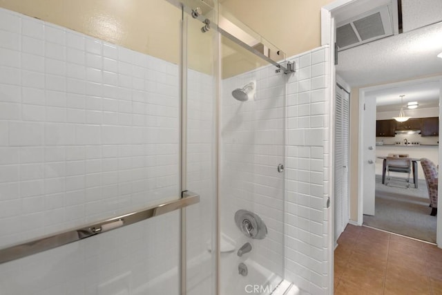 bathroom with shower / bath combination with glass door, connected bathroom, and tile patterned flooring