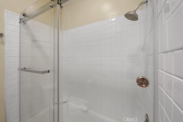 full bath featuring a shower stall
