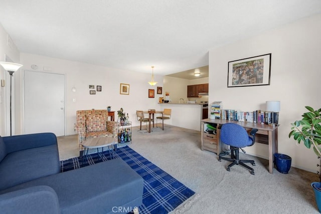 living area featuring light colored carpet and an office area