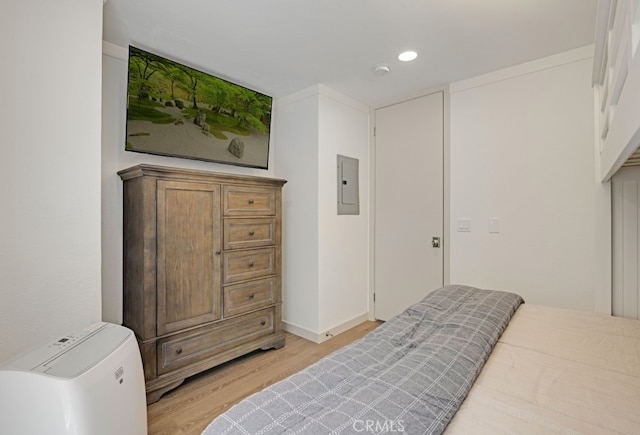 bedroom featuring light wood-type flooring, electric panel, recessed lighting, and baseboards