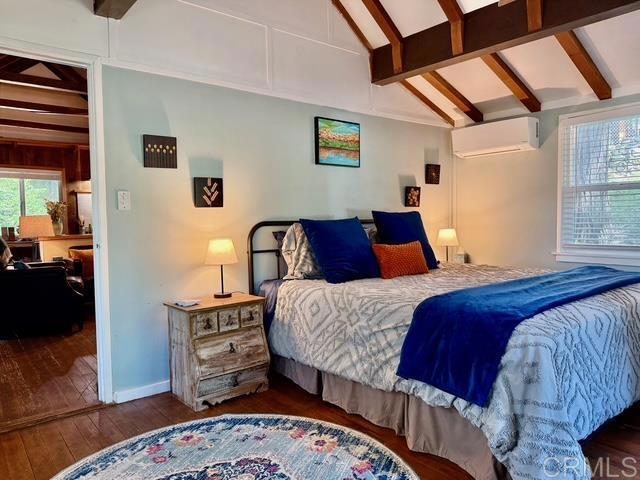 22104 Crestline, Palomar Mountain, CA 92060 - bedroom with an AC wall unit and hardwood / wood-style flooring