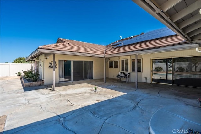 618 E Sunset Dr N, Redlands, CA 92373 - rear view of property featuring solar panels, a tiled roof, and a patio area